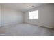 Bright, carpeted bedroom with a large window and neutral paint at 40000 W Bravo Dr, Maricopa, AZ 85138