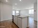 Open floor plan showcasing kitchen island with granite countertop and stainless steel dishwasher at 40000 W Bravo Dr, Maricopa, AZ 85138