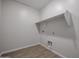Laundry room with tile floors, shelf for storage, and washer/dryer hook ups at 40000 W Bravo Dr, Maricopa, AZ 85138