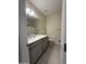 Clean bathroom with gray vanity and tiled floors at 24569 W Whyman Ave, Buckeye, AZ 85326