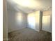 Spacious bedroom with double doors and carpet flooring at 24569 W Whyman Ave, Buckeye, AZ 85326