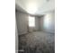 Simple bedroom with neutral decor and carpeted floor at 24569 W Whyman Ave, Buckeye, AZ 85326