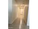 Bright hallway featuring tile flooring and neutral paint, leading to the front door at 24569 W Whyman Ave, Buckeye, AZ 85326