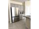 Modern kitchen with stainless steel refrigerator and gray cabinets at 24569 W Whyman Ave, Buckeye, AZ 85326