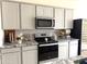 Modern kitchen with stainless steel appliances and granite countertops at 24569 W Whyman Ave, Buckeye, AZ 85326