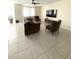 Bright living room with ample seating and tile flooring at 24569 W Whyman Ave, Buckeye, AZ 85326