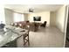 Open living room and kitchen area with tile flooring at 24569 W Whyman Ave, Buckeye, AZ 85326