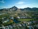 Stunning aerial view of the property with a golf course, a pond, and mountain views at 2626 E Arizona Biltmore Cir # 40, Phoenix, AZ 85016