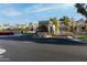 View of the community entrance featuring a secure gate and lush landscaping at 2626 E Arizona Biltmore Cir # 40, Phoenix, AZ 85016
