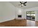 Inviting living room with wood floors, a fireplace, and sliding glass doors leading to outdoor patio at 2626 E Arizona Biltmore Cir # 40, Phoenix, AZ 85016