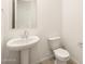 Clean bathroom with pedestal sink and toilet at 4033 S 177Th Ave, Goodyear, AZ 85338