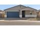 Newly built home with a blue garage door and neutral color scheme at 4033 S 177Th Ave, Goodyear, AZ 85338