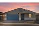 New construction home at sunset with a two-car garage at 4033 S 177Th Ave, Goodyear, AZ 85338