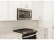 Modern kitchen with stainless steel appliances and white cabinetry at 4033 S 177Th Ave, Goodyear, AZ 85338
