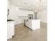 Modern kitchen with white cabinets, large island, and stainless steel appliances at 4033 S 177Th Ave, Goodyear, AZ 85338