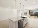 Modern kitchen with white cabinets, quartz countertops, and stainless steel appliances at 4033 S 177Th Ave, Goodyear, AZ 85338