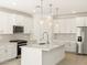 Bright kitchen featuring white cabinets, quartz countertops, and pendant lighting at 4033 S 177Th Ave, Goodyear, AZ 85338