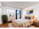 Light and airy bedroom with a light wood bed frame and blue accents at 11640 N 51St Ave # 250, Glendale, AZ 85304