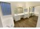 Elegant bathroom with double vanity, soaking tub, and glass block window at 15732 E Yucca Dr, Fountain Hills, AZ 85268