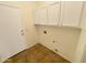 Laundry room with white cabinets and tile floor at 15732 E Yucca Dr, Fountain Hills, AZ 85268