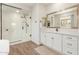 Modern bathroom with white cabinets, walk-in shower, and free-standing tub at 17243 W Seldon Ln, Waddell, AZ 85355