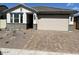 Charming single-story home with a well-maintained front yard and a spacious two-car garage at 18096 W Hiddenview Dr, Goodyear, AZ 85338