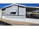Gray mobile home with covered patio and landscaping at 394 N Pinyon Dr, Apache Junction, AZ 85120