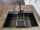 Modern kitchen sink with black matte faucet and dish drying rack at 394 N Pinyon Dr, Apache Junction, AZ 85120