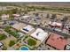 Beautiful aerial view of a desert home with a pool and lush green landscaping in a gated community at 923 W Crooked Stick Dr, Casa Grande, AZ 85122