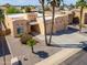 Aerial view of a home with desert landscaping, three car garage, and tile roof at 923 W Crooked Stick Dr, Casa Grande, AZ 85122