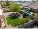Aerial view of a home with a swimming pool and landscaped backyard featuring synthetic lawn at 923 W Crooked Stick Dr, Casa Grande, AZ 85122