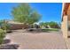 Charming backyard with brick pavers, mature trees, and landscaped synthetic lawn at 923 W Crooked Stick Dr, Casa Grande, AZ 85122