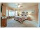Spacious bedroom with large windows, a ceiling fan, and plush carpet at 923 W Crooked Stick Dr, Casa Grande, AZ 85122