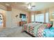 Bright bedroom with a large window, a ceiling fan, and a comfortable sitting area at 923 W Crooked Stick Dr, Casa Grande, AZ 85122