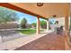 Inviting covered patio with stamped concrete, manicured synthetic lawn, and mature landscaping at 923 W Crooked Stick Dr, Casa Grande, AZ 85122