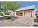 Spacious covered patio with brick pavers overlooking manicured synthetic lawn at 923 W Crooked Stick Dr, Casa Grande, AZ 85122