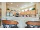 View of kitchen showcasing the breakfast bar, raised ceilings, and ample cabinet space at 923 W Crooked Stick Dr, Casa Grande, AZ 85122