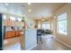 Bright, open kitchen featuring ample cabinetry, bar seating and a view of the dining area at 923 W Crooked Stick Dr, Casa Grande, AZ 85122