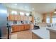 Well-lit kitchen with abundant wood cabinets, neutral countertops, and a practical layout at 923 W Crooked Stick Dr, Casa Grande, AZ 85122
