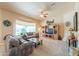 Cozy living room with plush seating, a ceiling fan, and a bright window view at 923 W Crooked Stick Dr, Casa Grande, AZ 85122