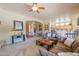 Open-concept living room with cozy seating, archways and connections to kitchen and entryway at 923 W Crooked Stick Dr, Casa Grande, AZ 85122