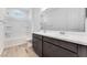 Bathroom featuring dual sink vanity, wood look flooring, and tiled shower-tub at 3804 S Buttercup --, Mesa, AZ 85212