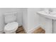 Powder room with a toilet, pedestal sink and wood look tile floors at 3804 S Buttercup --, Mesa, AZ 85212