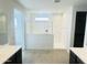 Bathroom with double vanities, a glass enclosed shower, and a neutral color palette at 3804 S Buttercup --, Mesa, AZ 85212