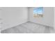 Bright bedroom featuring gray carpet, a window, and white walls at 3804 S Buttercup --, Mesa, AZ 85212