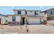 Two-story home with neutral paint, stone accents, brick driveway, and a two-car garage at 3804 S Buttercup --, Mesa, AZ 85212