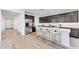 Modern kitchen featuring dark cabinetry, a white quartz island with bar seating, and stainless steel appliances at 3804 S Buttercup --, Mesa, AZ 85212
