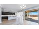 Open-concept kitchen featuring dark cabinetry, stainless steel appliances, and a seamless transition to outdoor patio at 3804 S Buttercup --, Mesa, AZ 85212