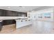 Open-concept kitchen with an island, stainless appliances, and views of the living area at 3804 S Buttercup --, Mesa, AZ 85212