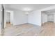 Open-concept living area with wood-style flooring, and a view of a bathroom and hall at 3804 S Buttercup --, Mesa, AZ 85212
